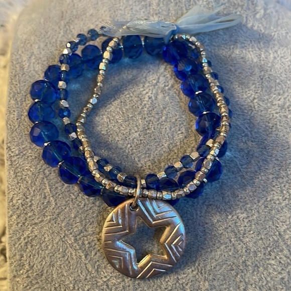 Set of 3 connected blue and silver jewel like bracelets with a star charm. - Picture 3 of 5